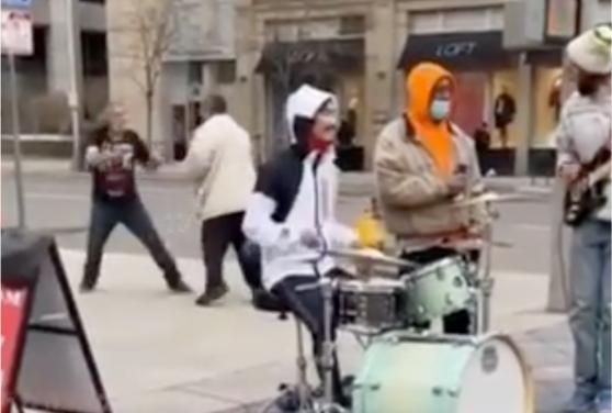 Men Decide To Play Fisticuffs While A Band Jams Out!